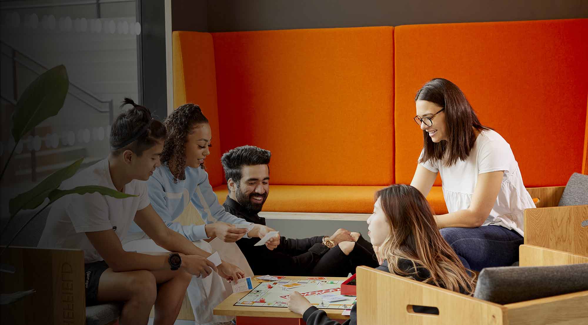 Young people playing a board game in student accommodation